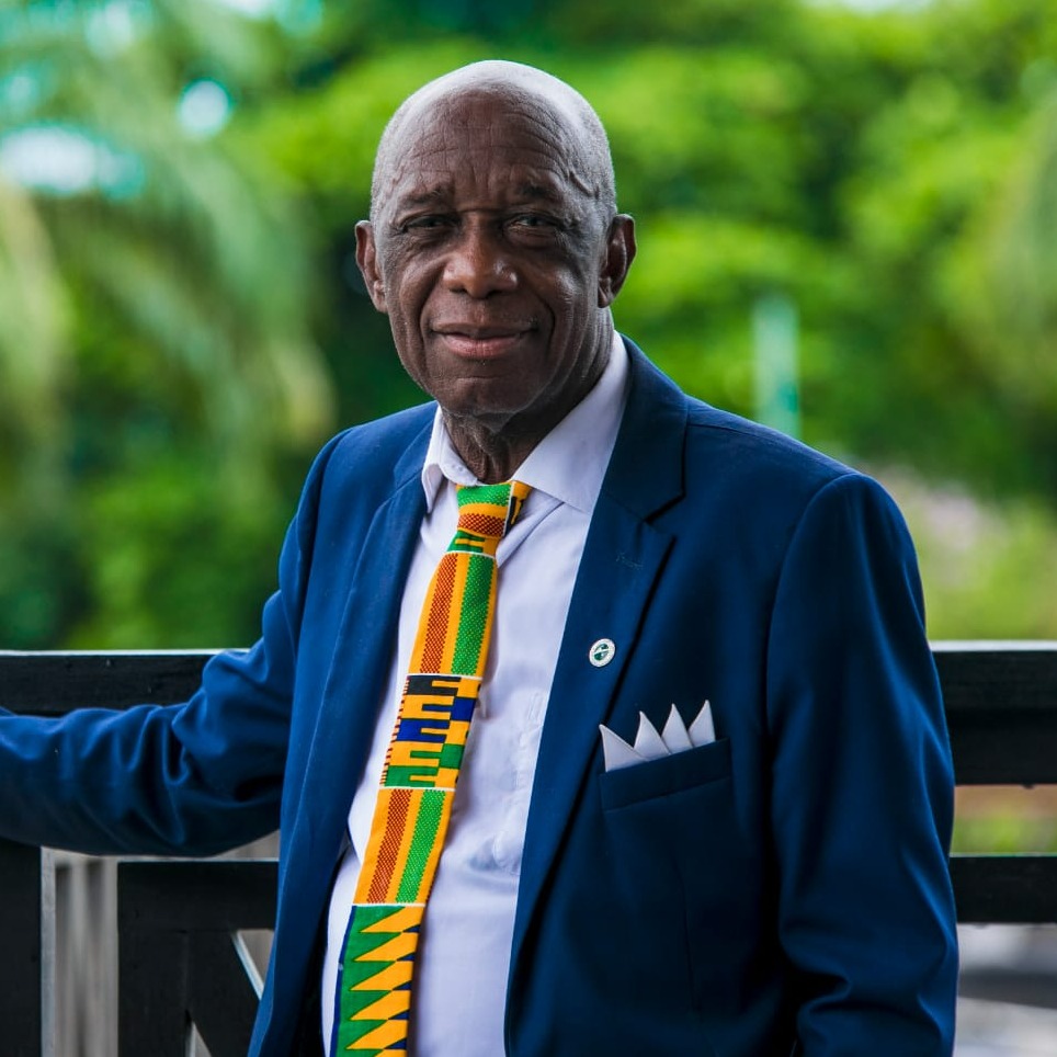 Image of male outdoors in a suit wearing an African print tie