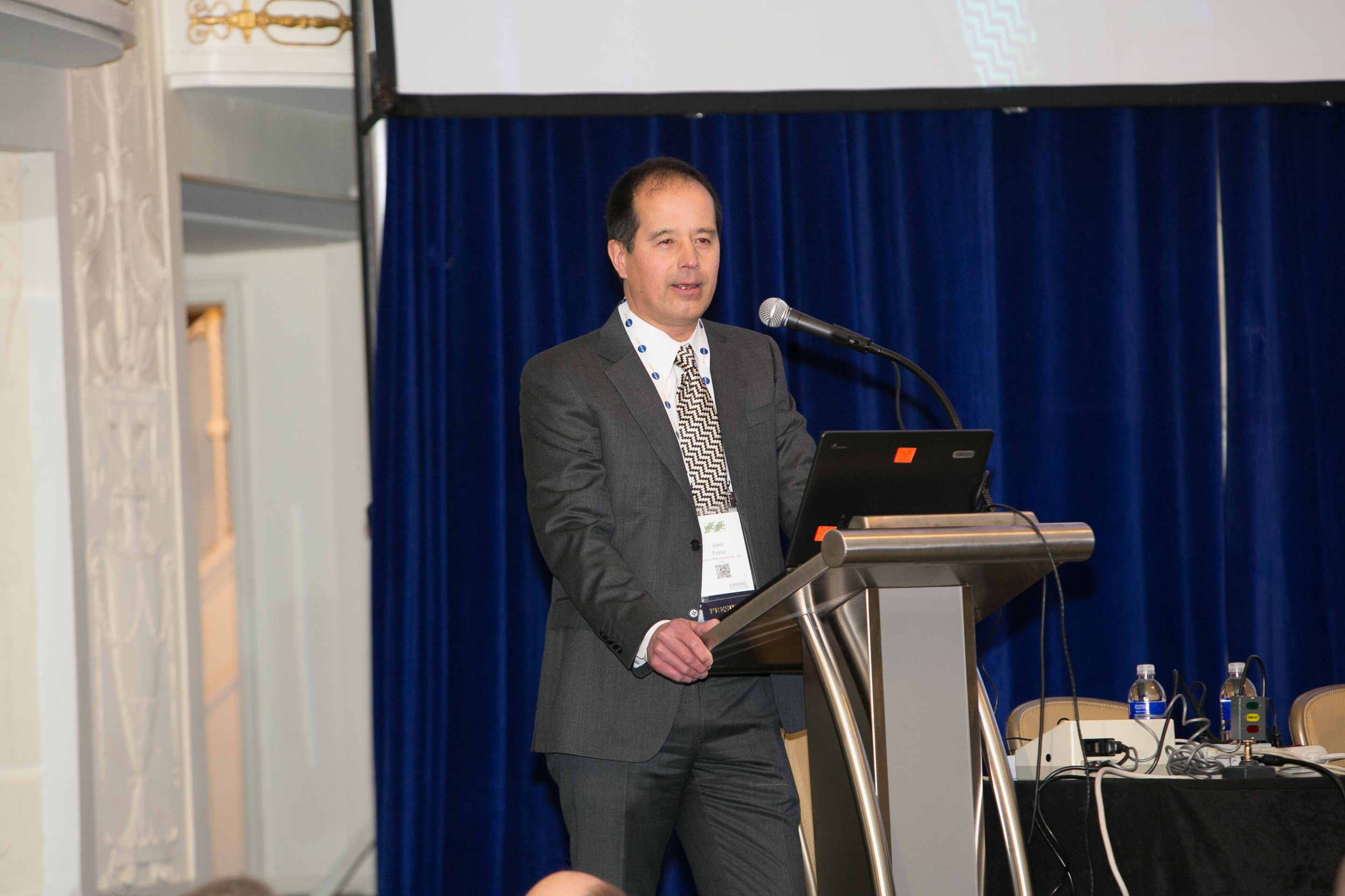 Image of male wearing business suit presenting on stage at CASSS WCBP 2016.