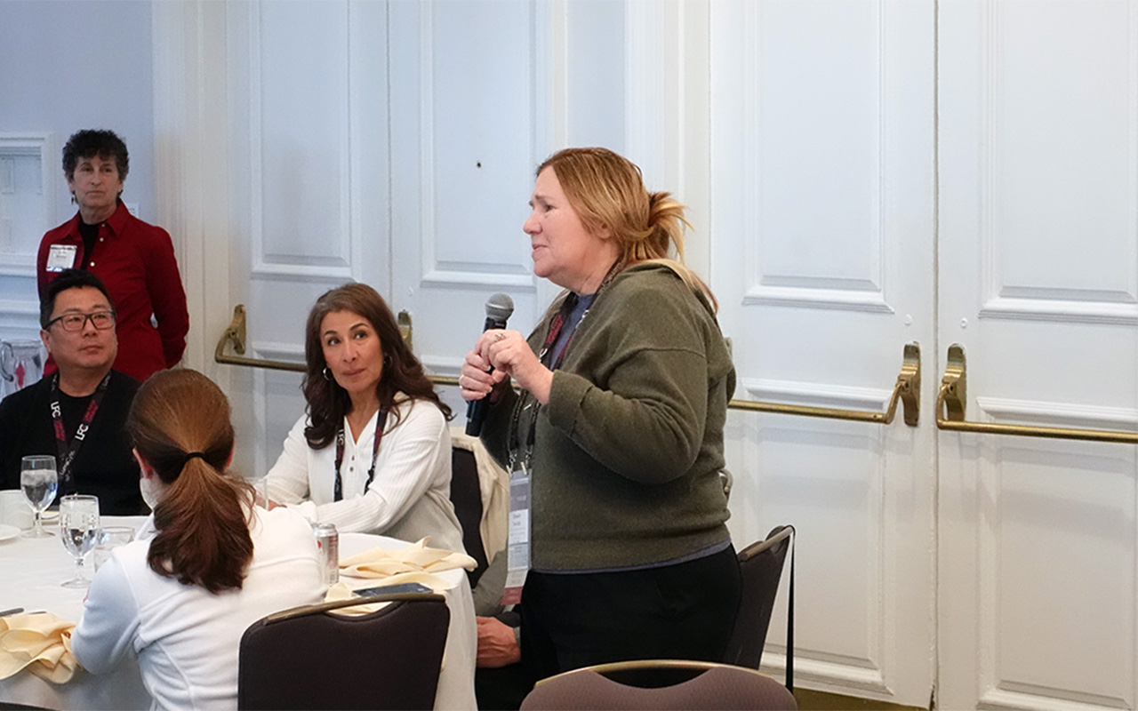 Photo of female speaking with a microphone